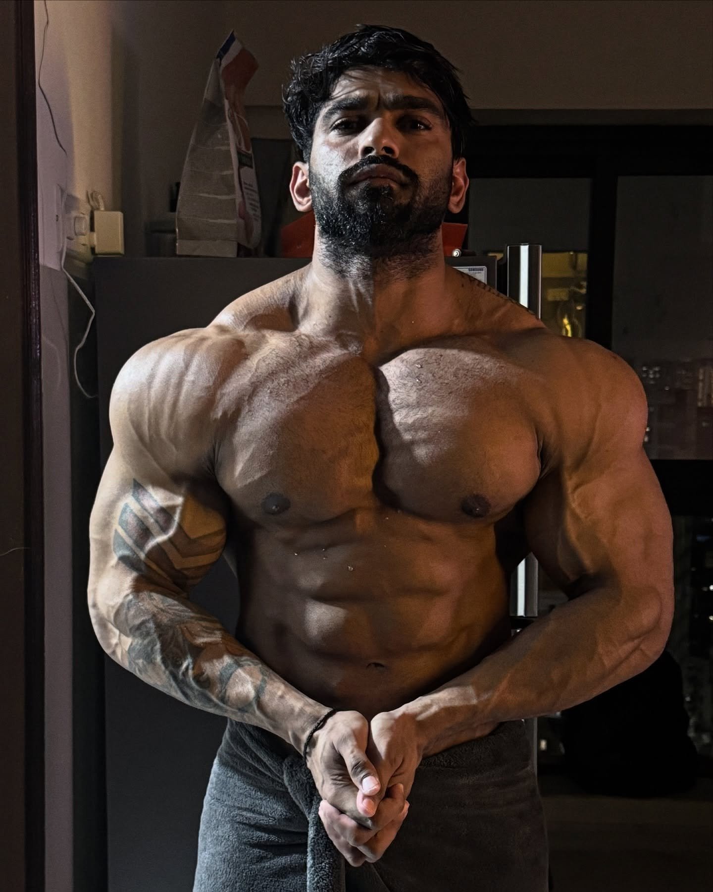 Amit Agre showing his physique in a mirror selfie, tattooed right arm visible