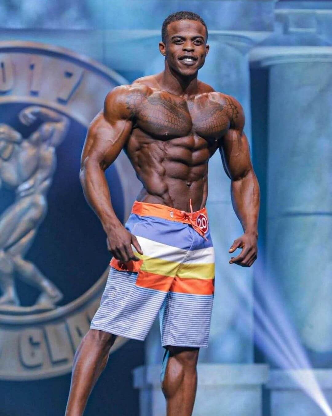 Andre Ferguson on stage in multicolour board shorts