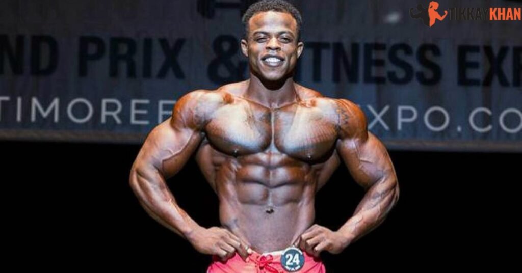 Andre Ferguson on stage in red board shorts