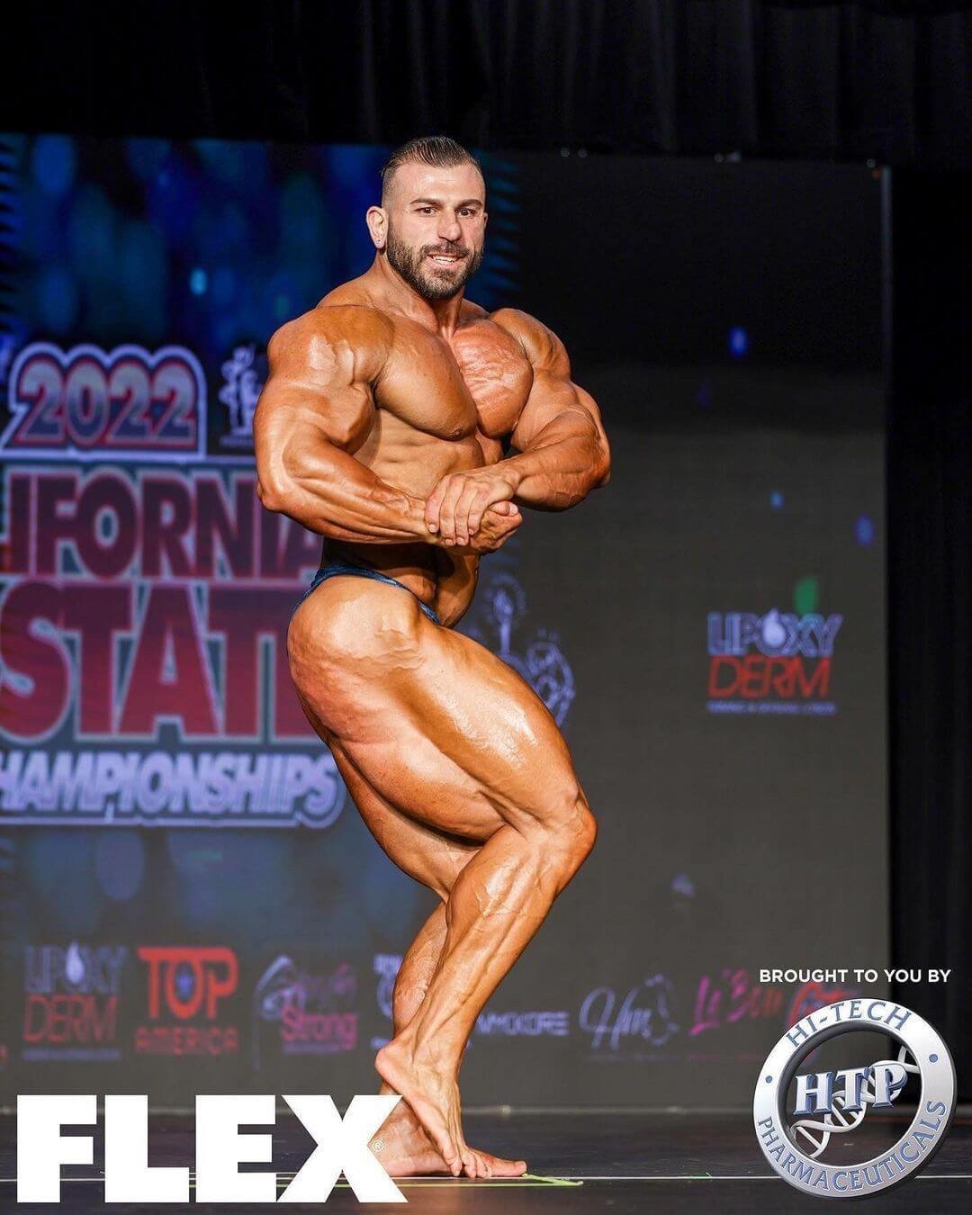 Andrea Muzi hitting a side chest pose at the 2022 California State Pro