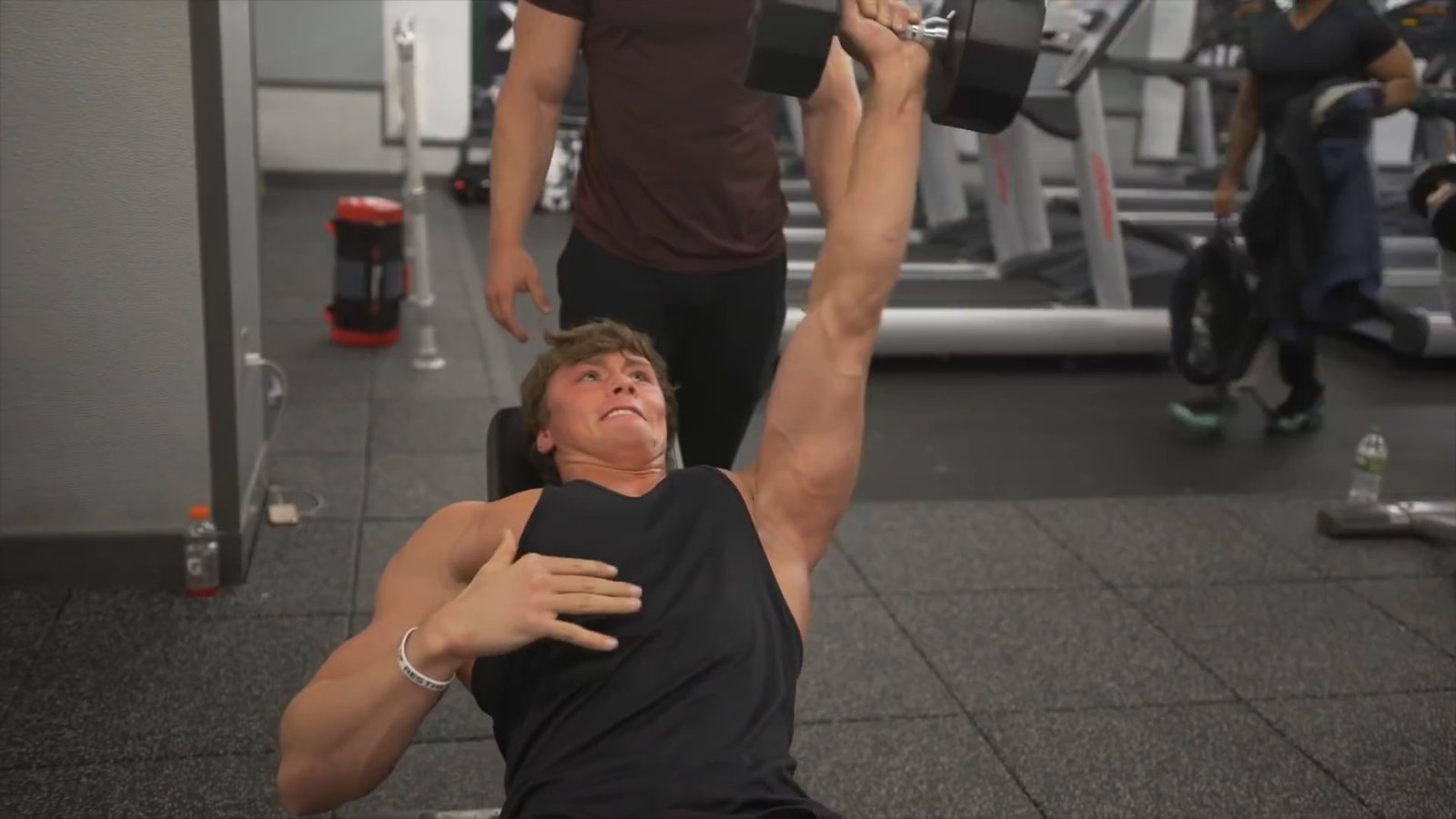 David Laid performing a dumbbell press during a gym training session in 2017
