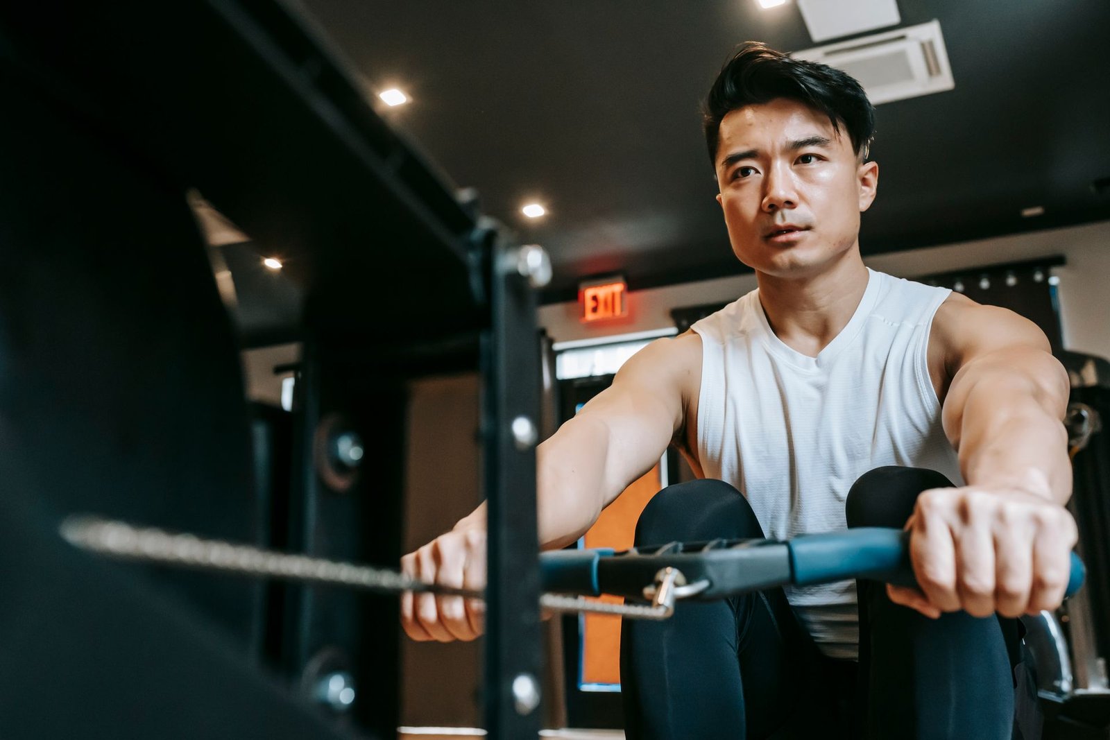 Man training with full effort on an indoor rowing machine