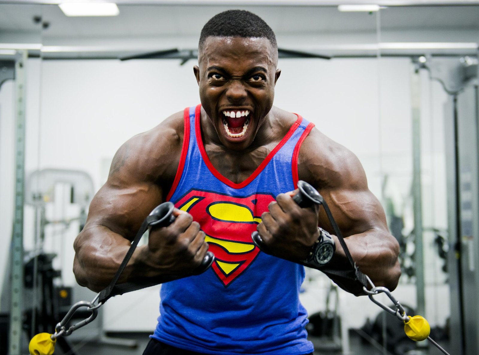A bodybuilder performing cable flyes in a gym
