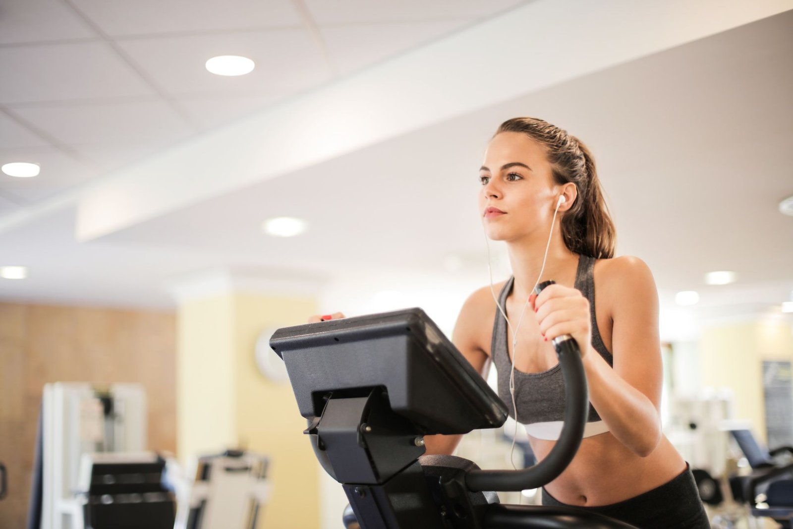 Woman training steadily on an elliptical machine
