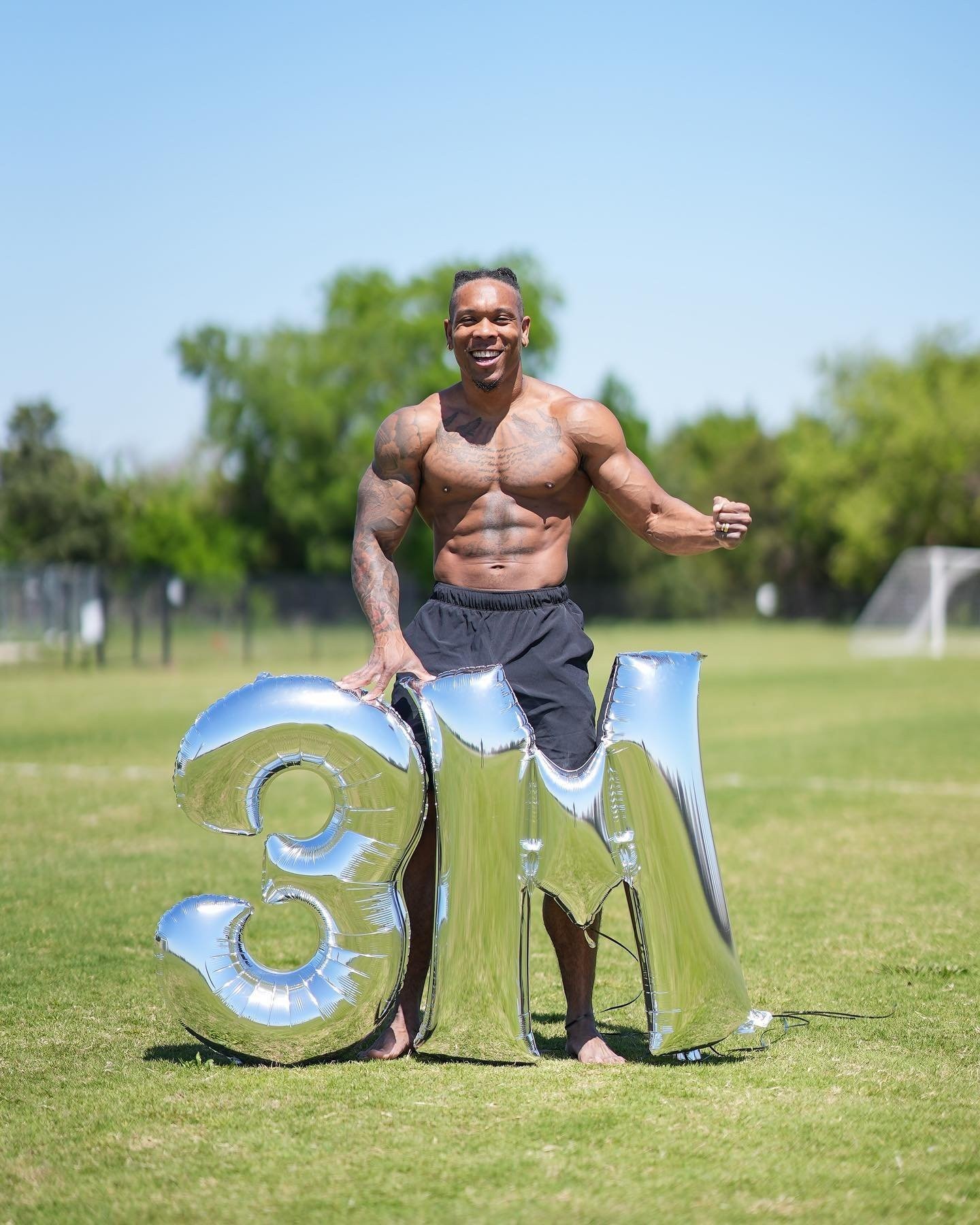 Bully Juice outdoors on grass with silver 3M balloons