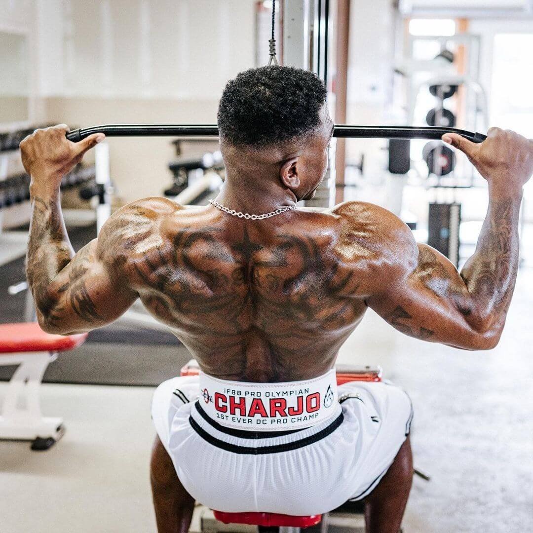 Charjo Grant training back in the gym, wearing his IFBB Pro Olympian belt