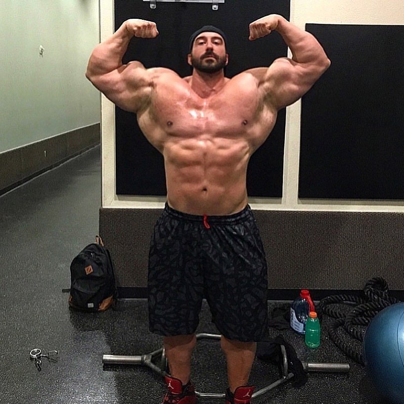 Craig Golias hitting a front double biceps pose in the gym