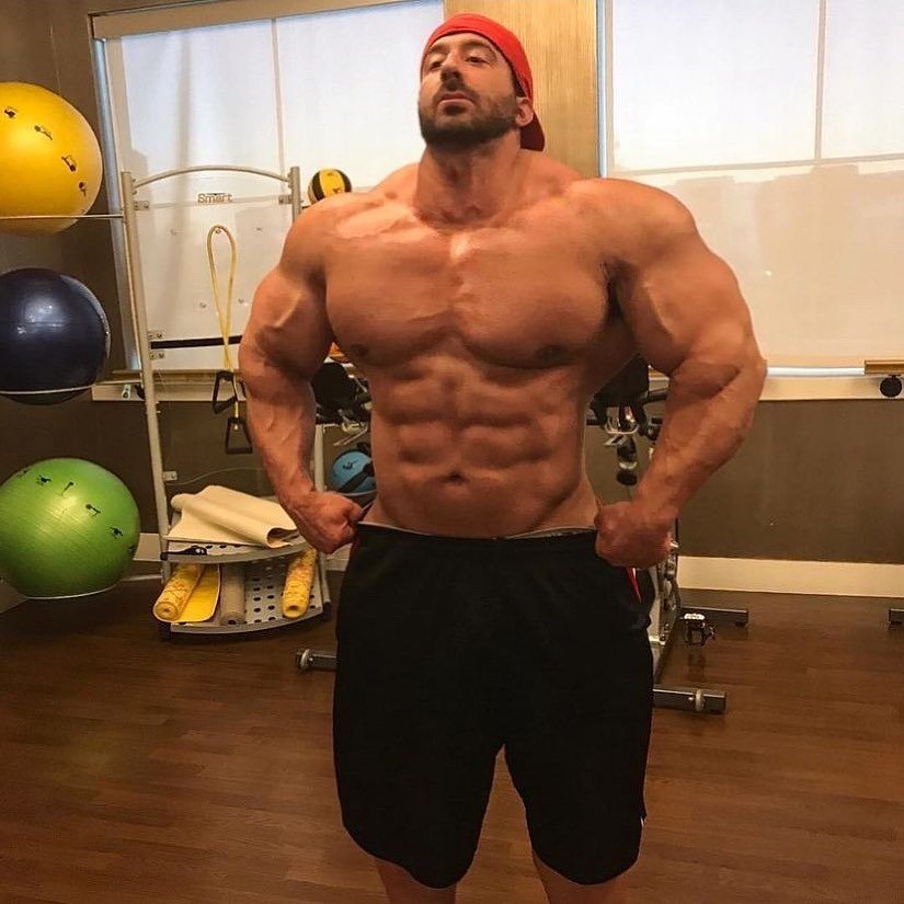 Craig Golias posing in the gym, showing his full upper-body size