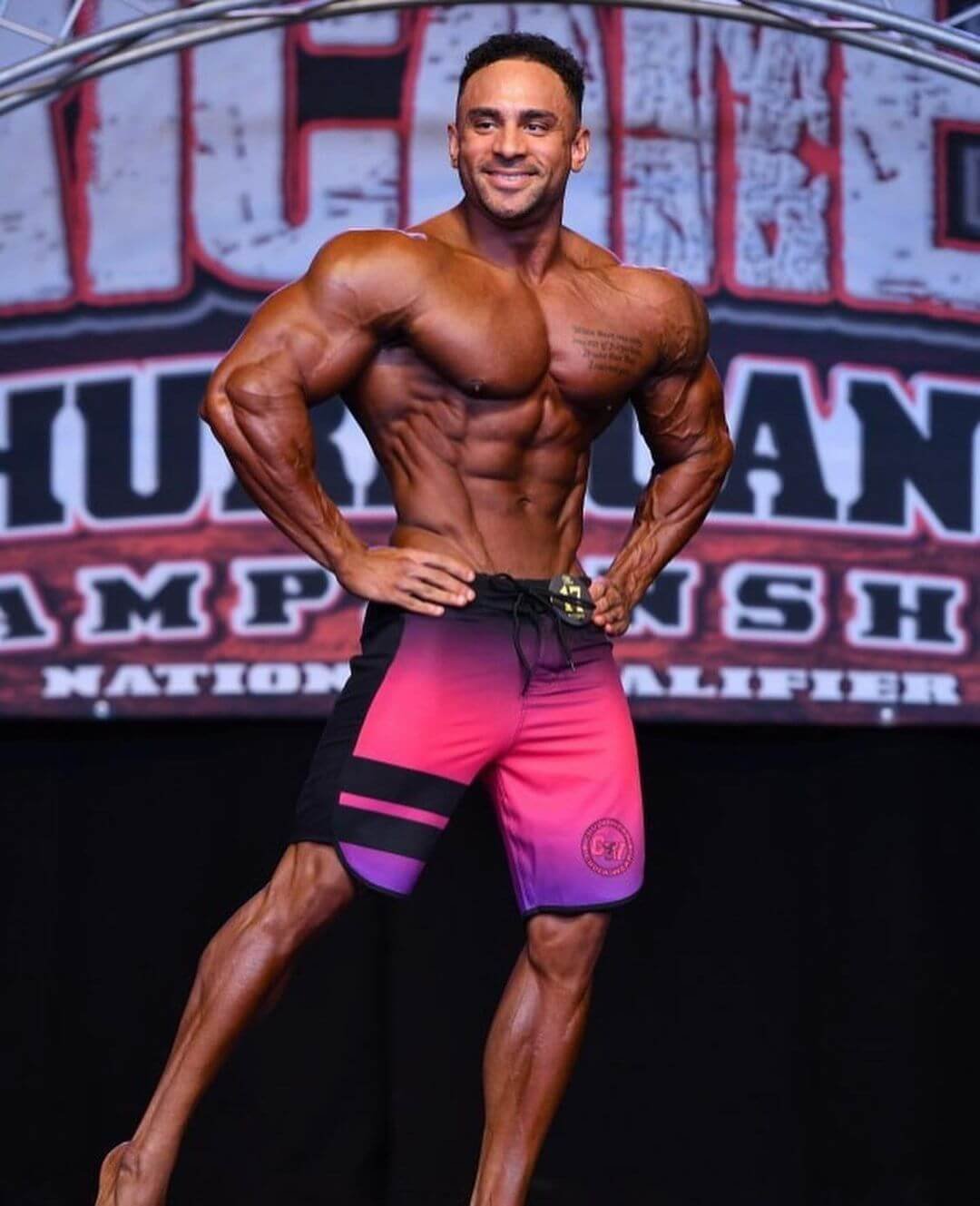 Daniel Ammons front pose on stage, Hurricane Pro backdrop