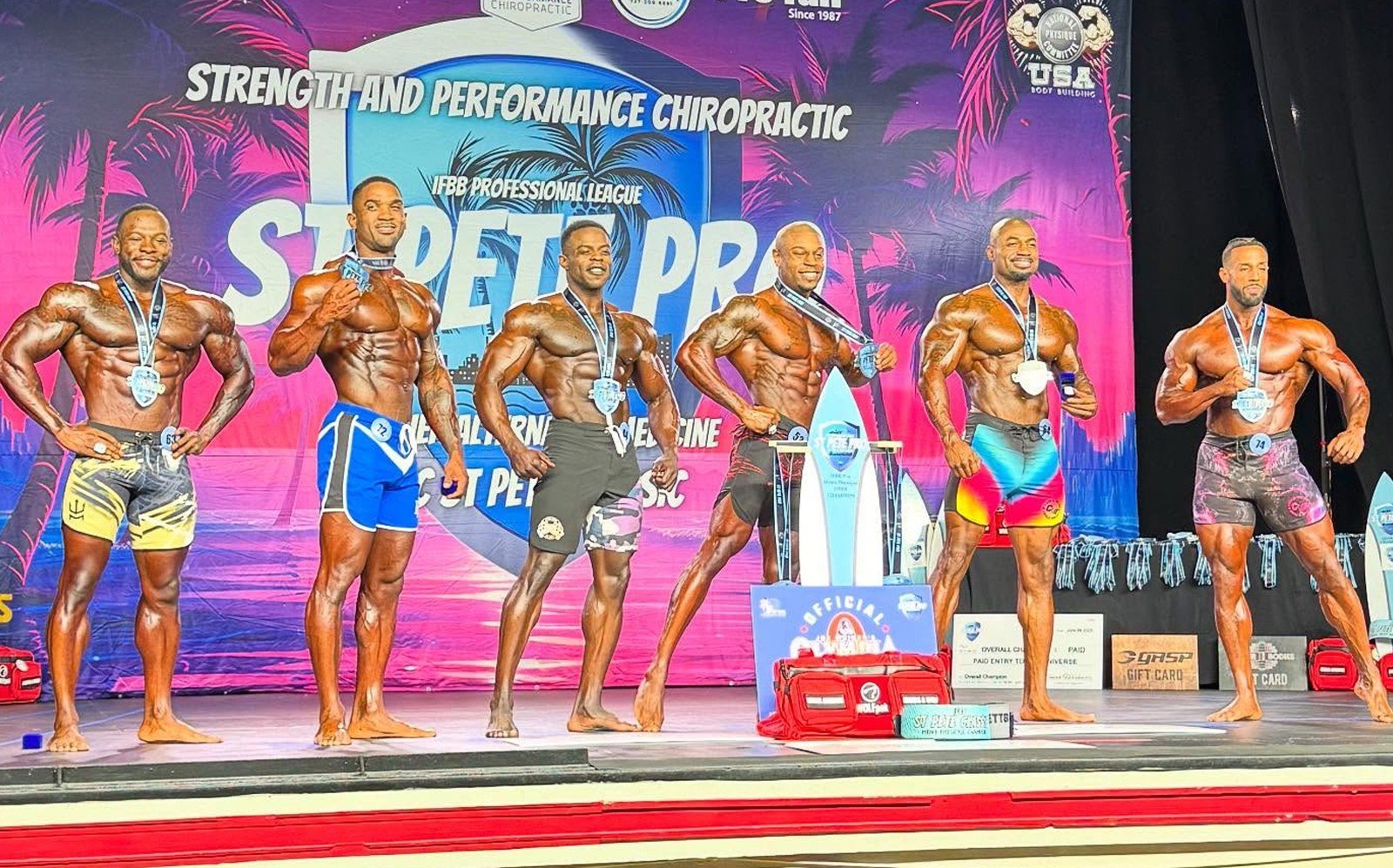 Dustin Alvis with his winner's medal beside the trophies at the 2025 St Pete Pro, alongside the other medalists