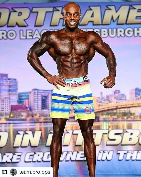 Dustin Alvis on stage at the 2020 NPC North American Championships in Pittsburgh, wearing competitor number 739