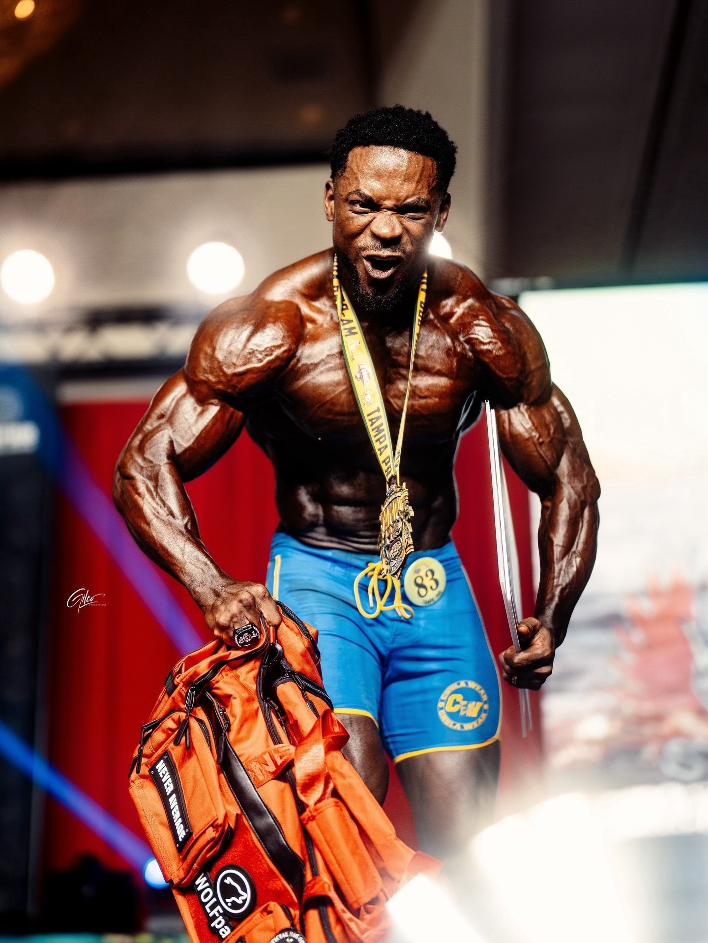Emanual Hunter wearing his Tampa Pro winner's medal and holding his trophy sword and winner's bag