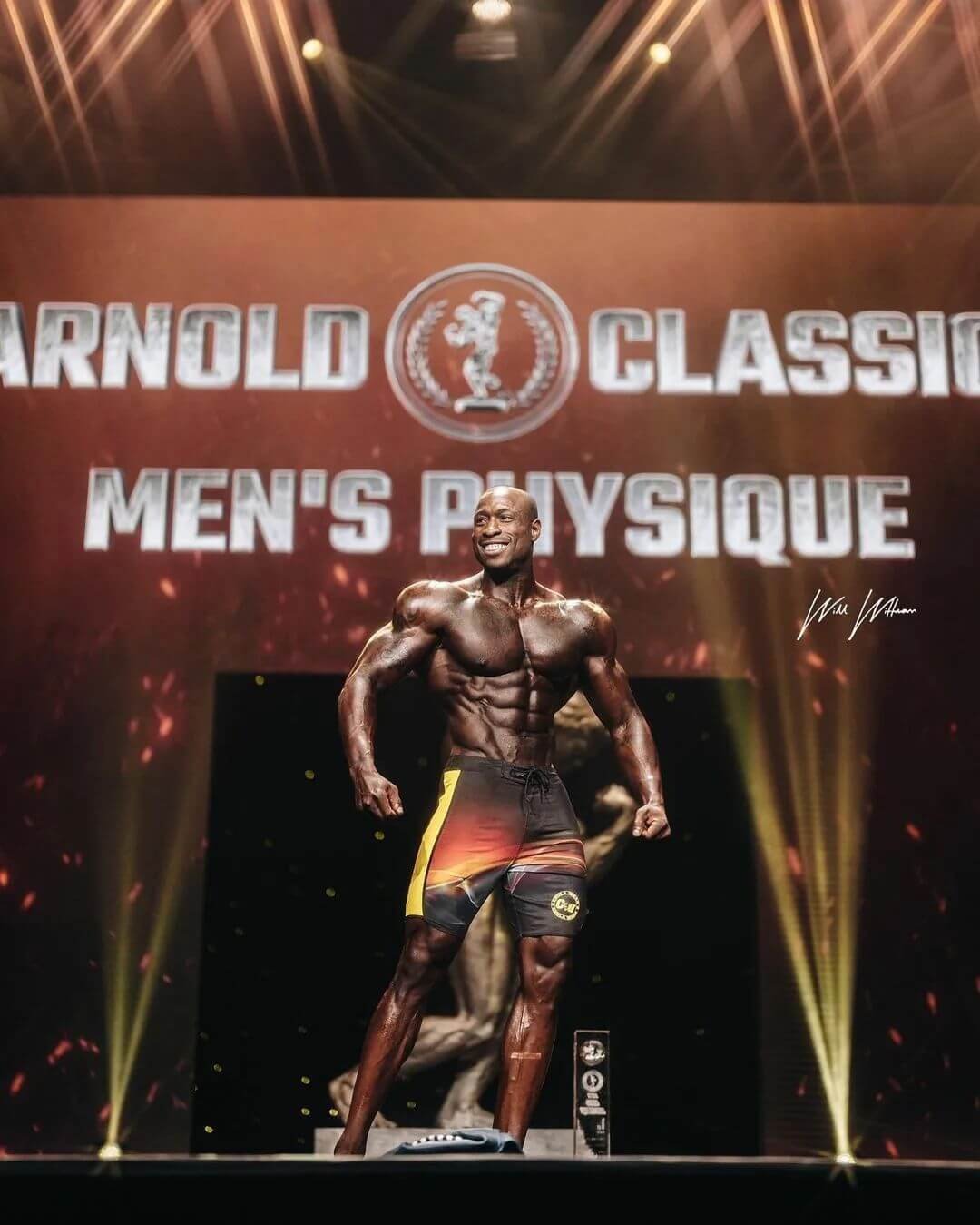 Erin Banks with his trophy on the Arnold Classic stage