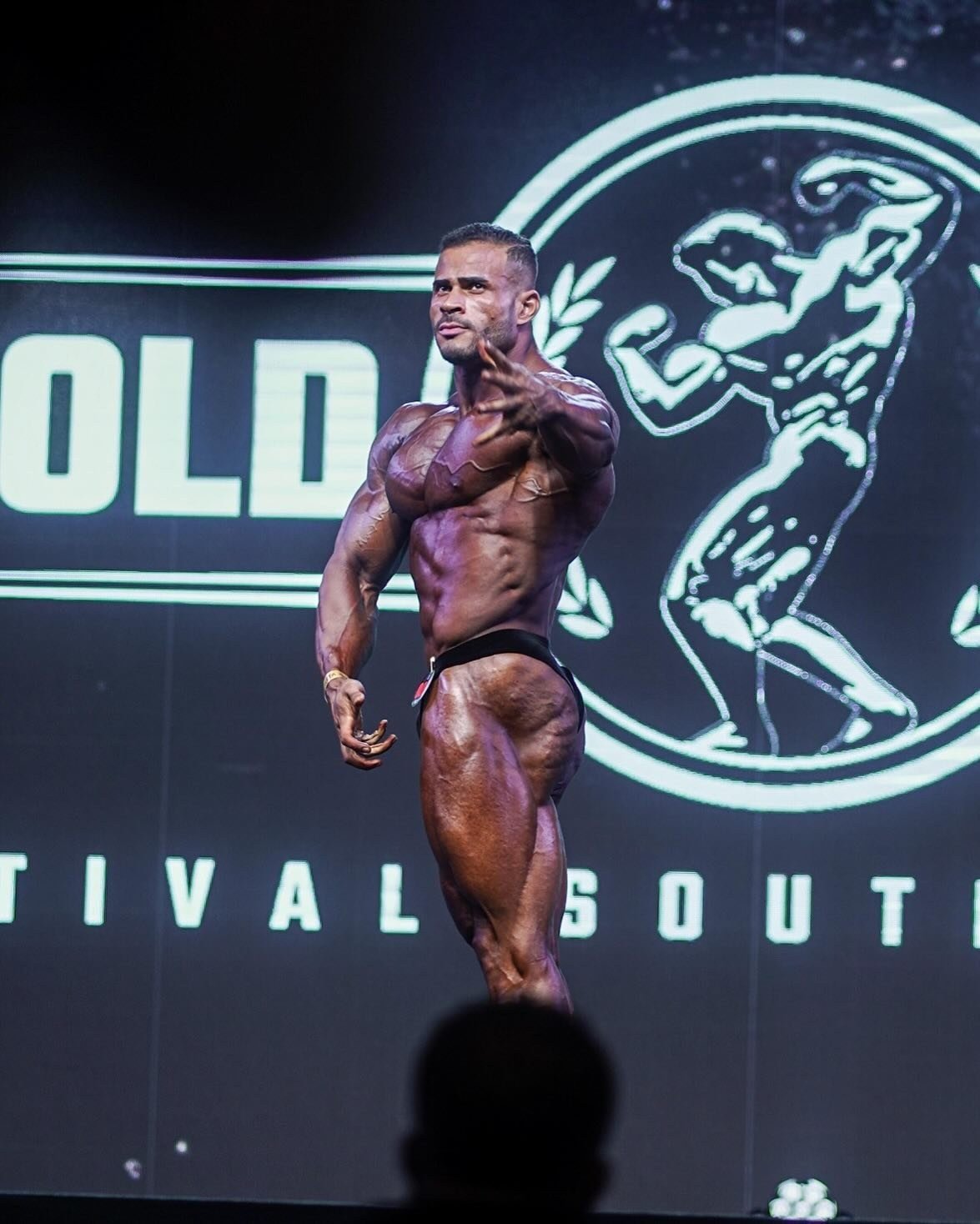 Fabio Junio posing on stage at the Arnold Classic South America