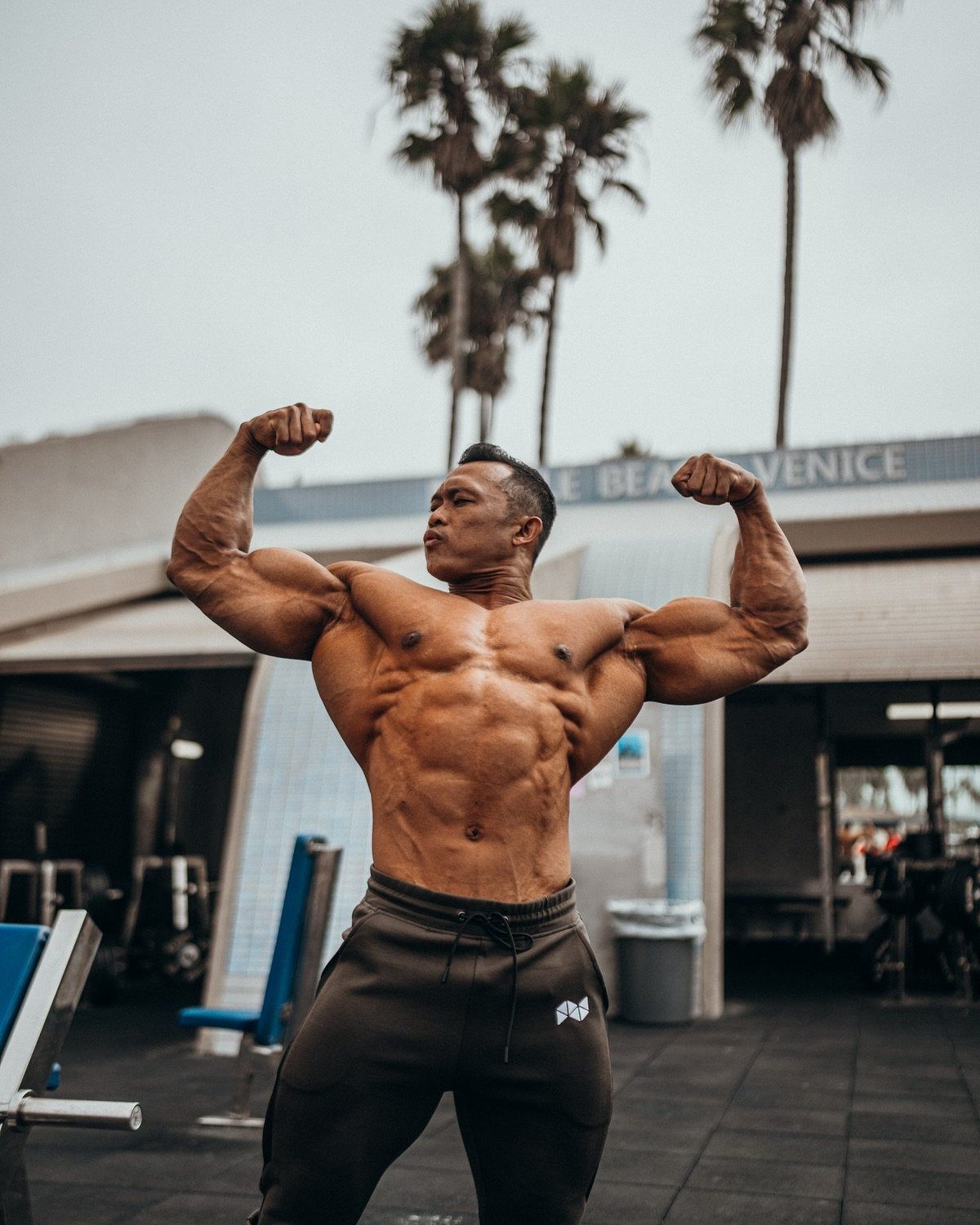 Fanni Fuadi hitting a front double biceps pose at Muscle Beach Venice