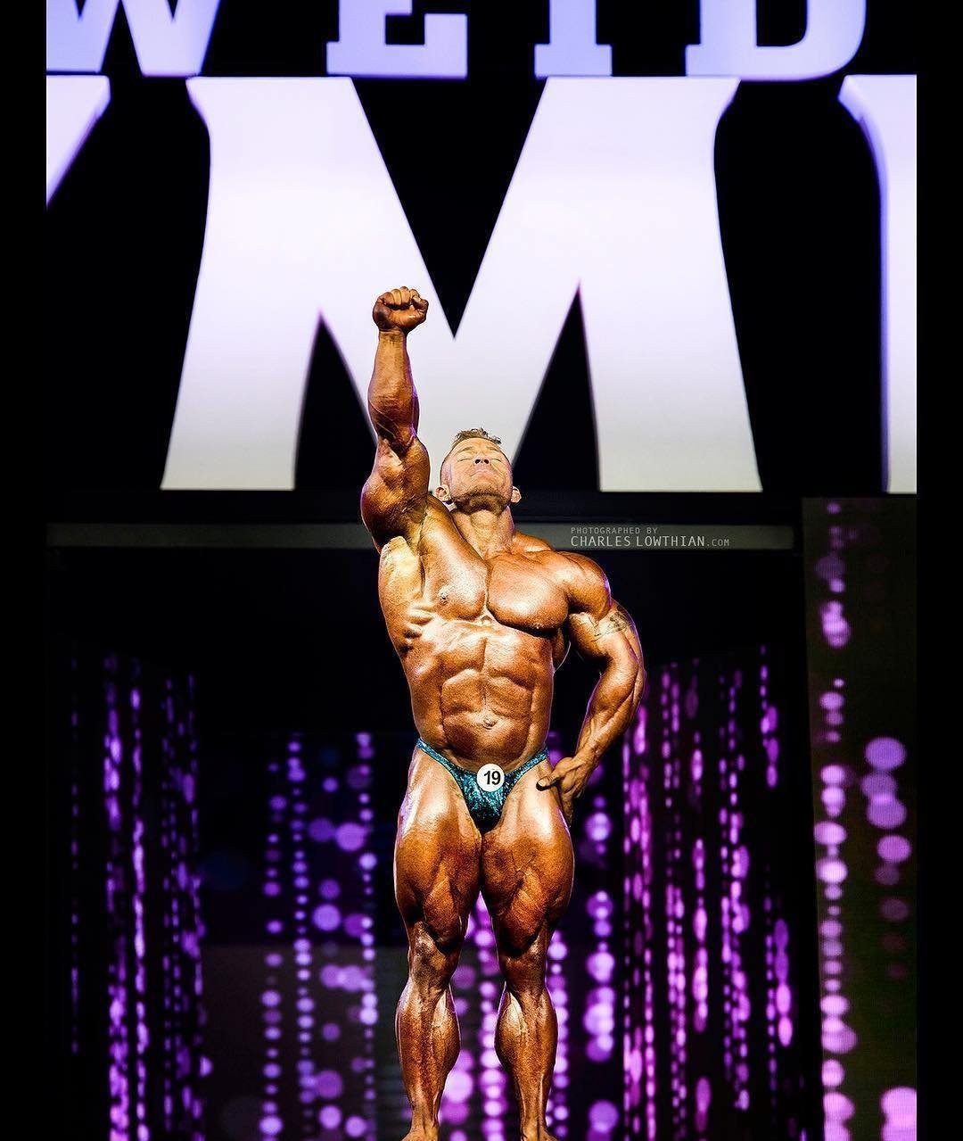 Flex Lewis celebrating on the Olympia stage with one arm raised
