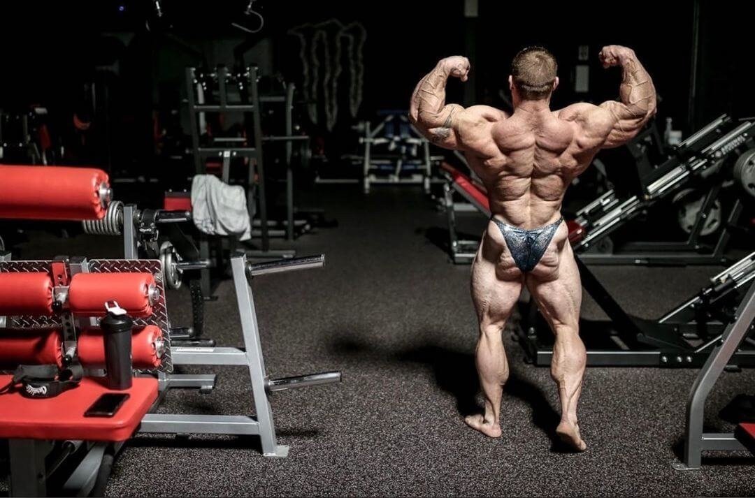 Flex Lewis showing his back in a back double-biceps pose in the gym