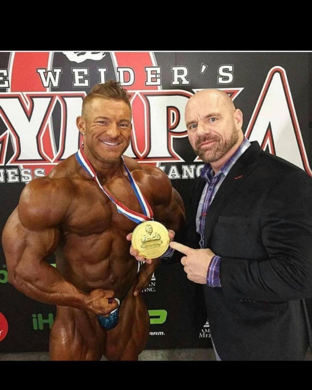 Flex Lewis holding his Mr. Olympia gold medal