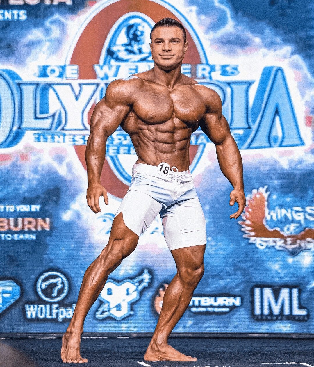 Furkan Er on stage at the Olympia, competitor number 18