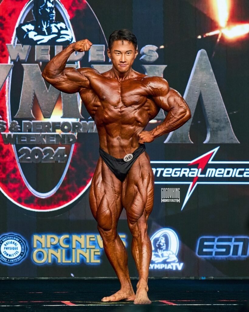 Jaehun Park posing on stage at the 2024 Mr. Olympia