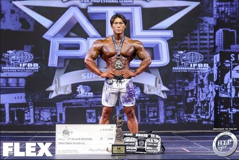 Jo Uezato holding his winner's medal, trophy and first-place cheque at the 2025 Lenda Murray Atlanta Pro
