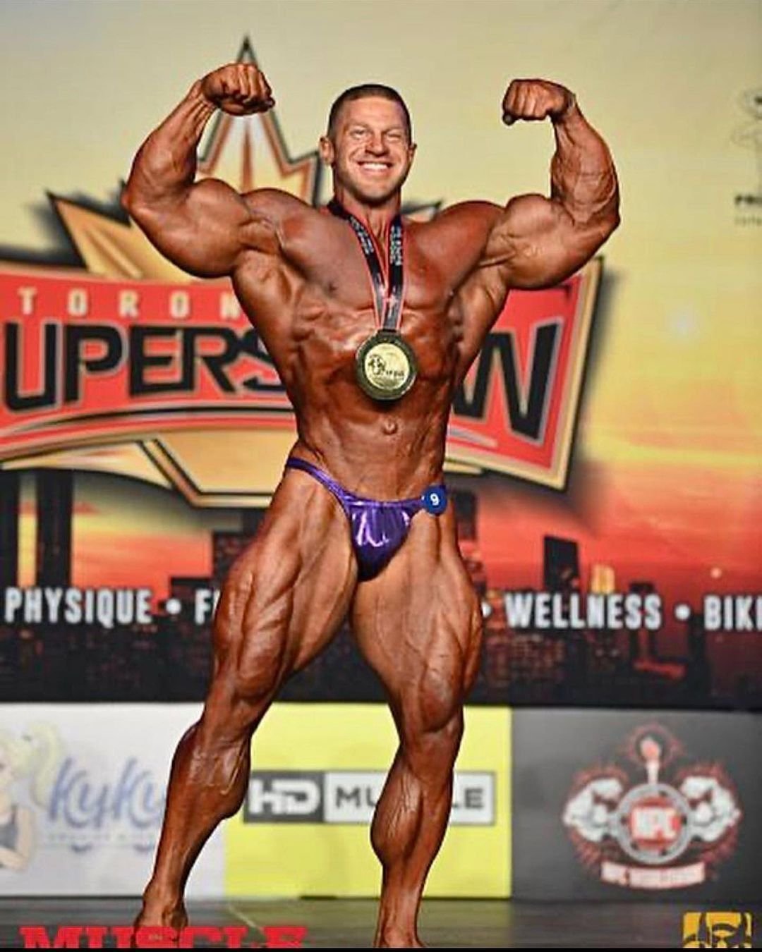 Joel Thomas on stage at the Toronto Pro Supershow with a winner's medal