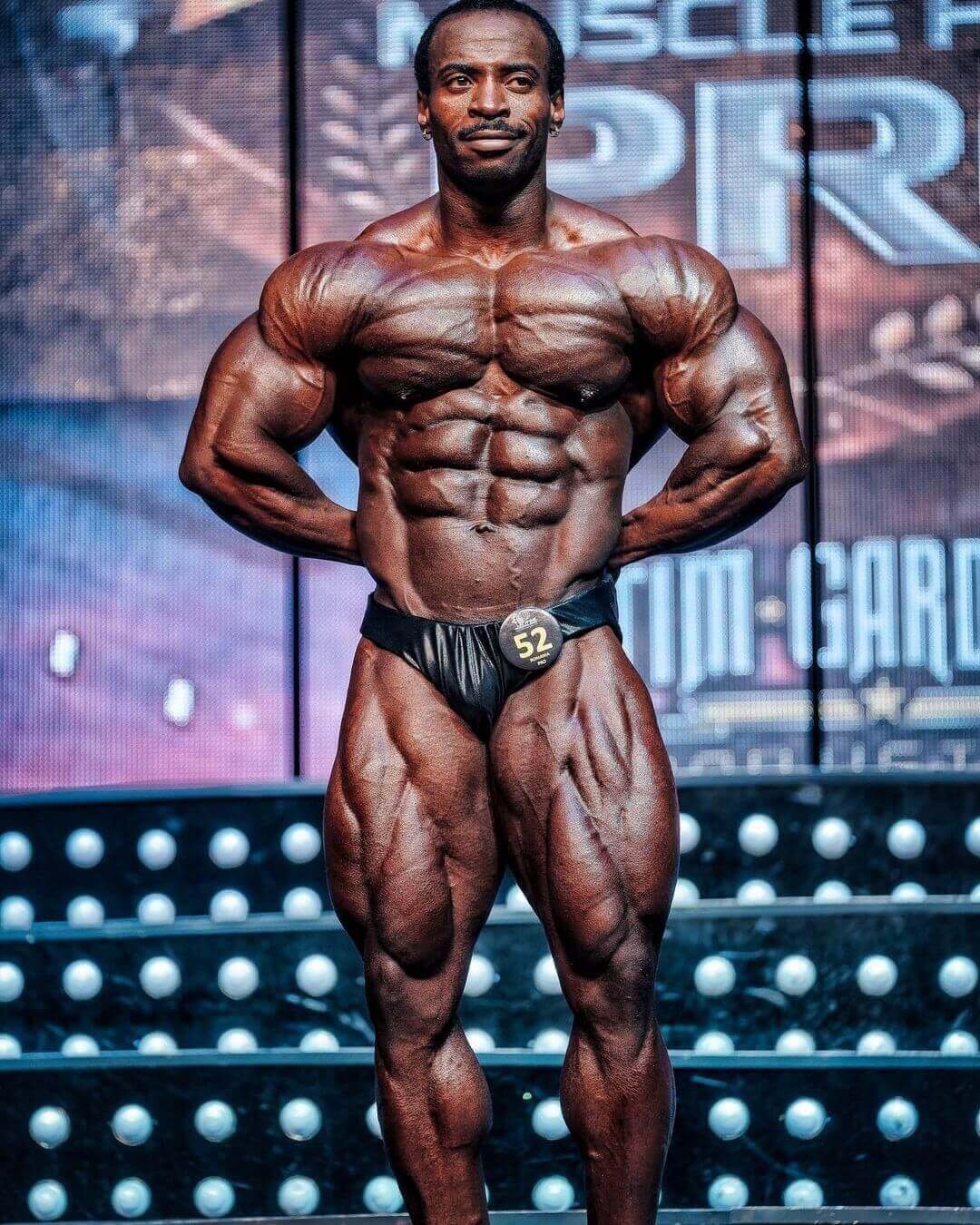Jose María Mete Bueriberi on stage in a front pose during a bodybuilding competition