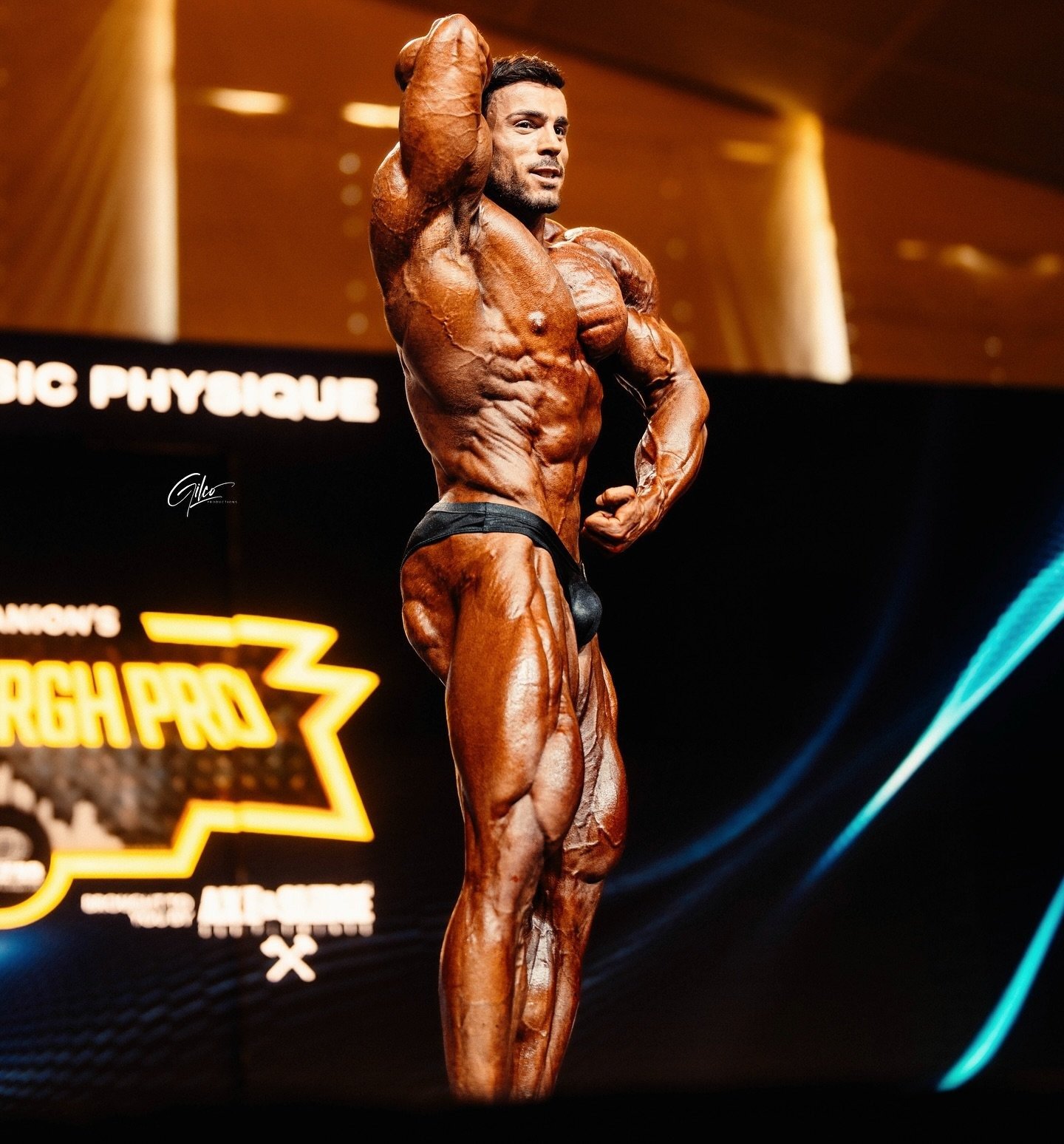 Josema Muñoz hitting a side pose on stage at the 2025 Pittsburgh Pro