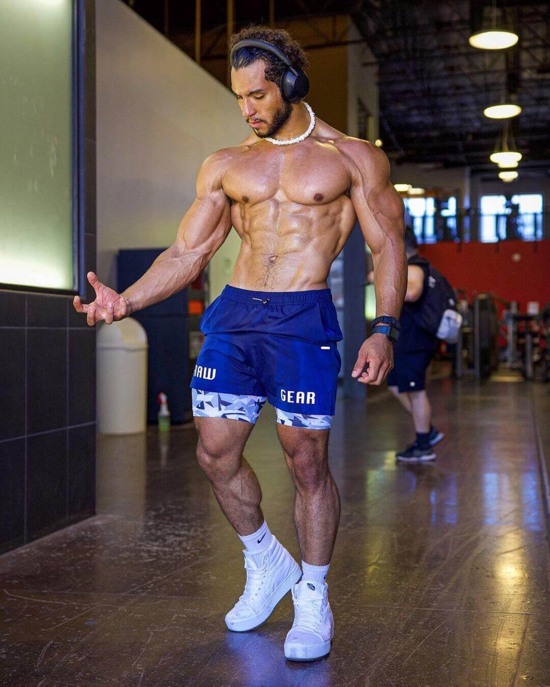 Joshua Manoi in the gym in blue training shorts