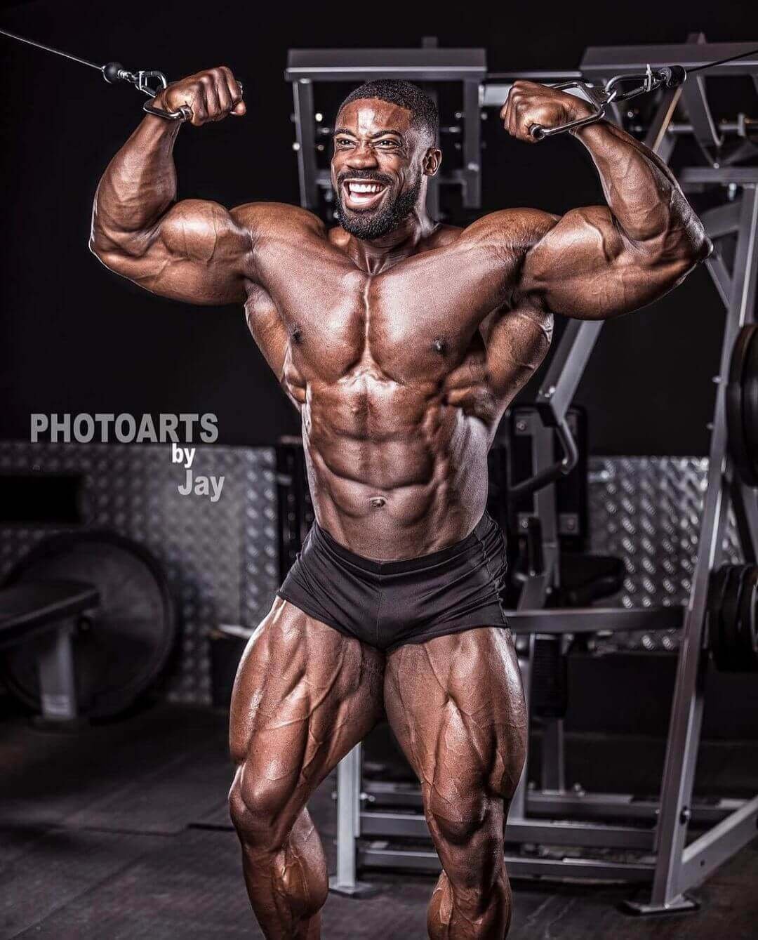 Marc Hector performing a cable crossover pose in the gym