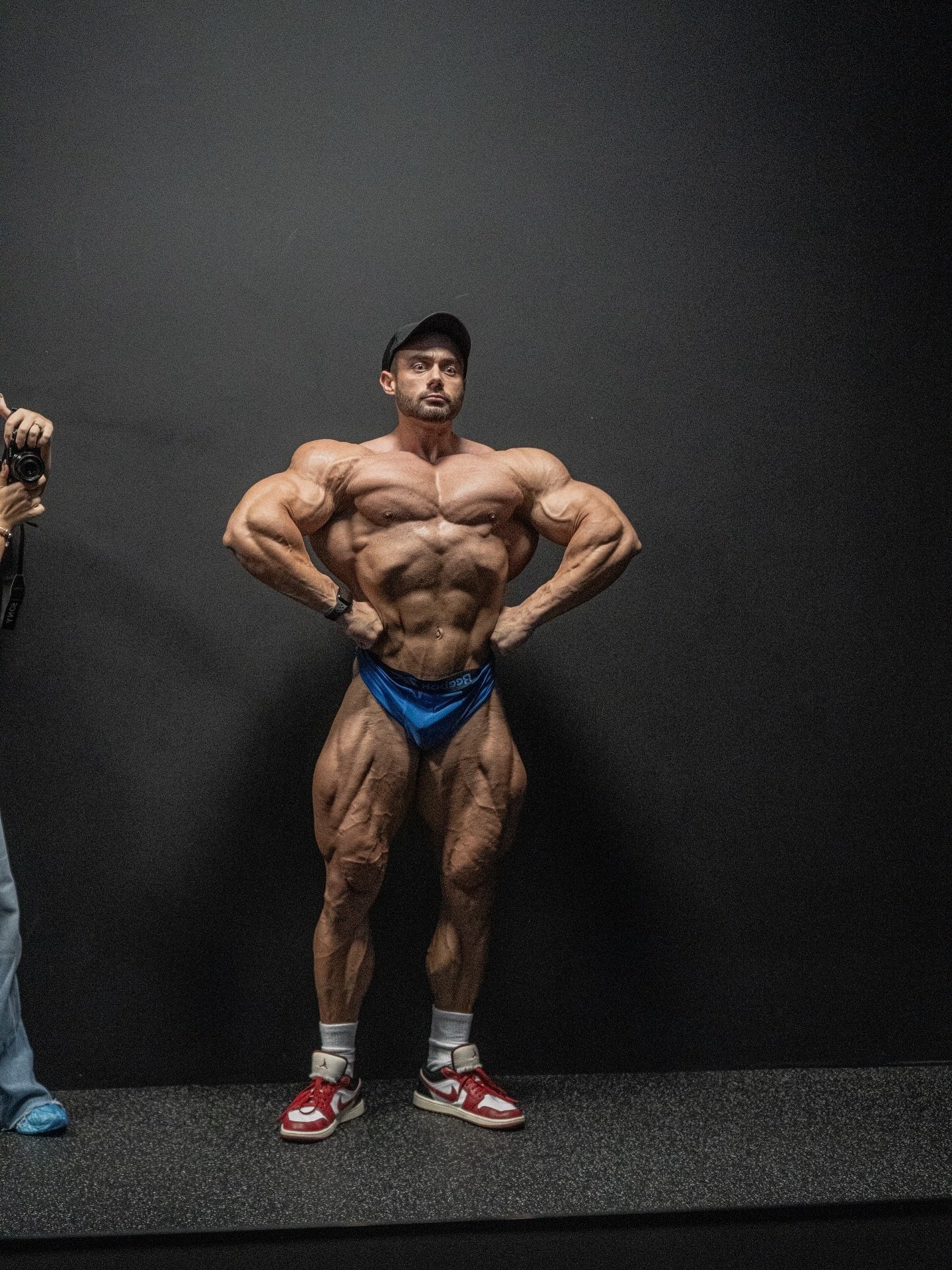 Richard Nagy holding a front lat spread backstage before competing