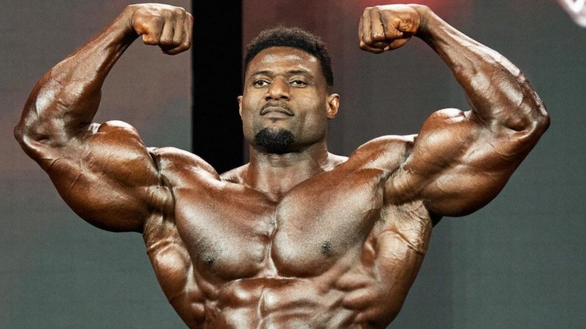 Andrew Jacked hitting a front double biceps pose in 2023