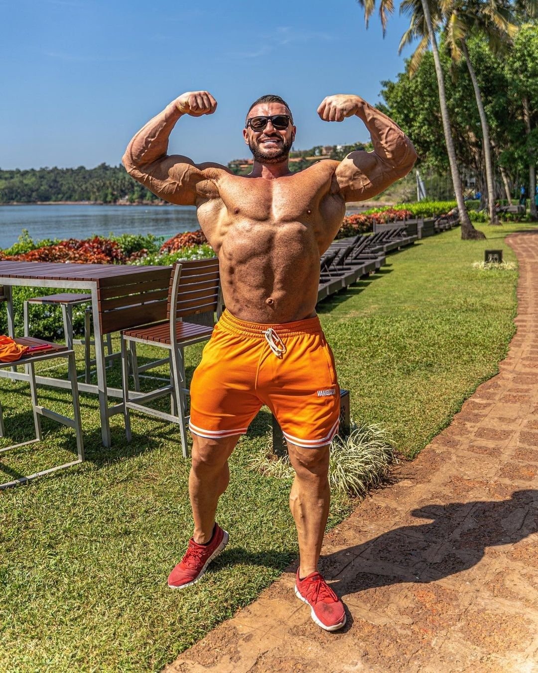 Ryan Crowley flexing a double biceps pose outdoors