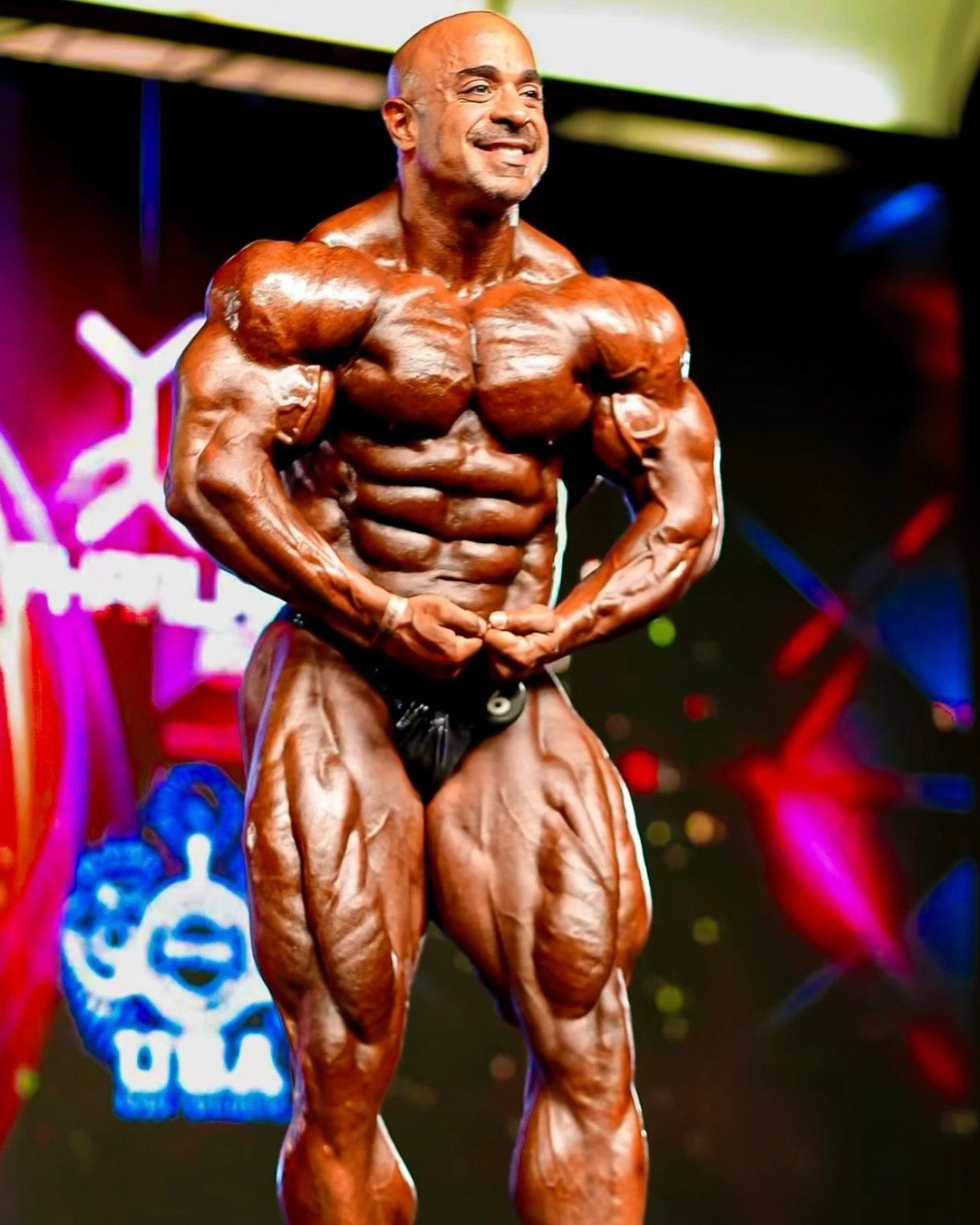 Sasan Heirati hitting a most muscular pose on a pro bodybuilding stage