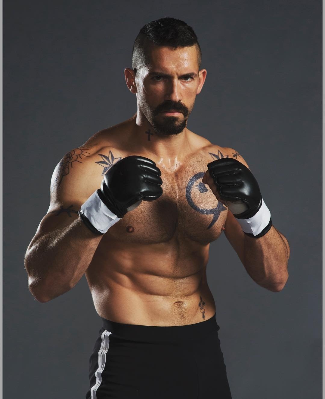 Scott Adkins in fighting shape with MMA gloves, in the look made famous by his Yuri Boyka role