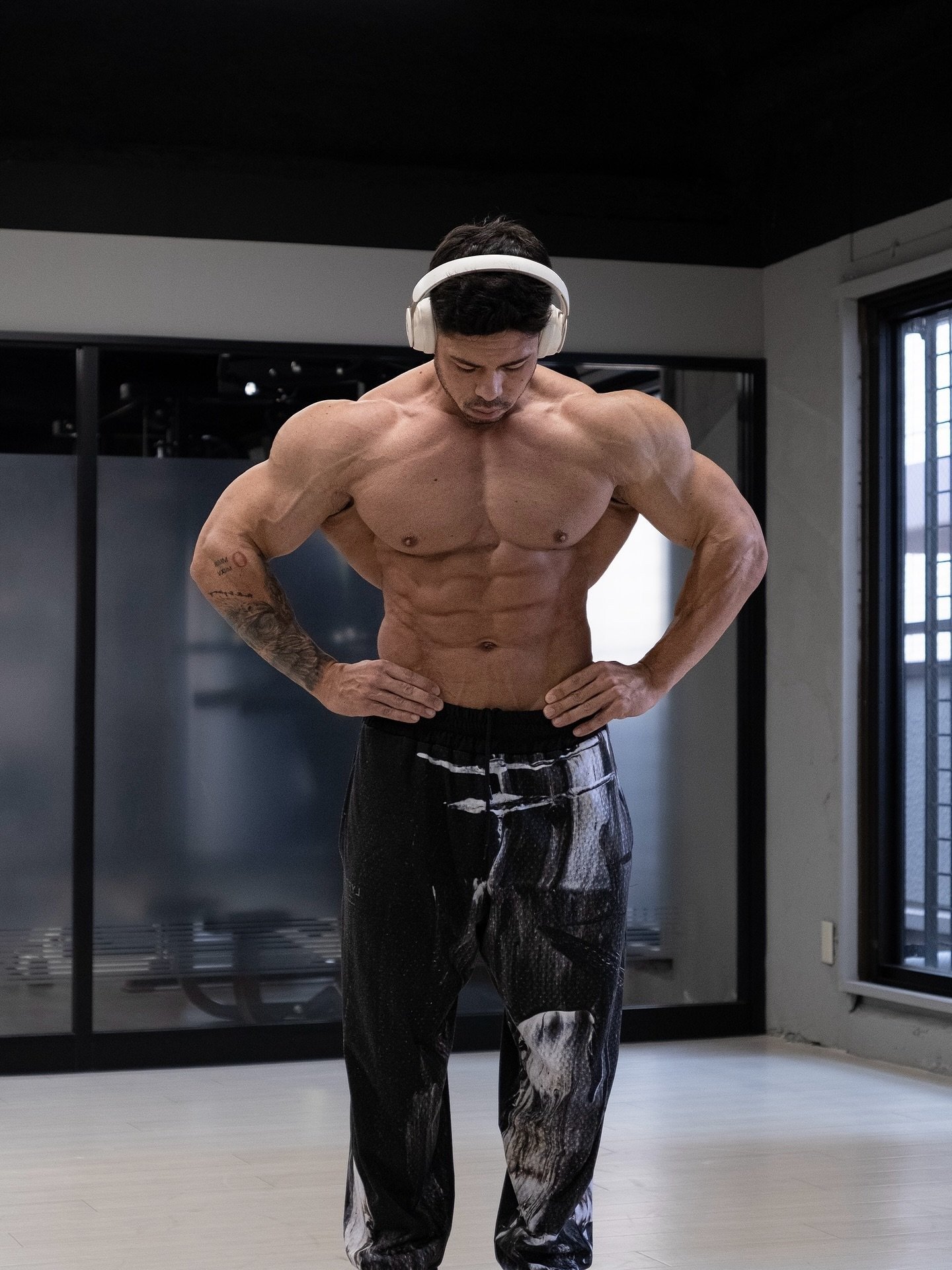 Shun Kaneko posing in the gym wearing headphones