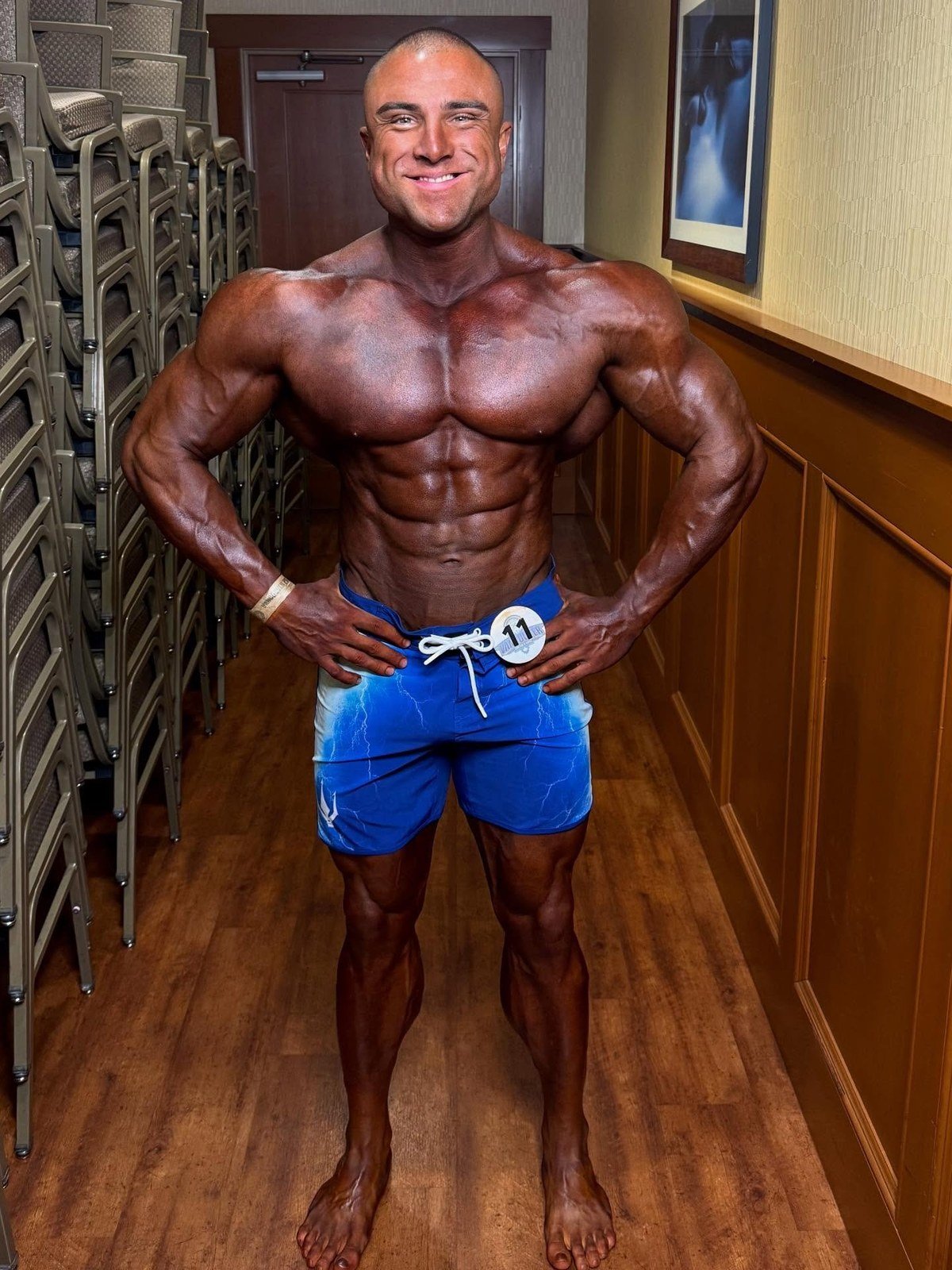Sotiris Gatsis backstage wearing competitor number 11 at the 2025 Vancouver Pro