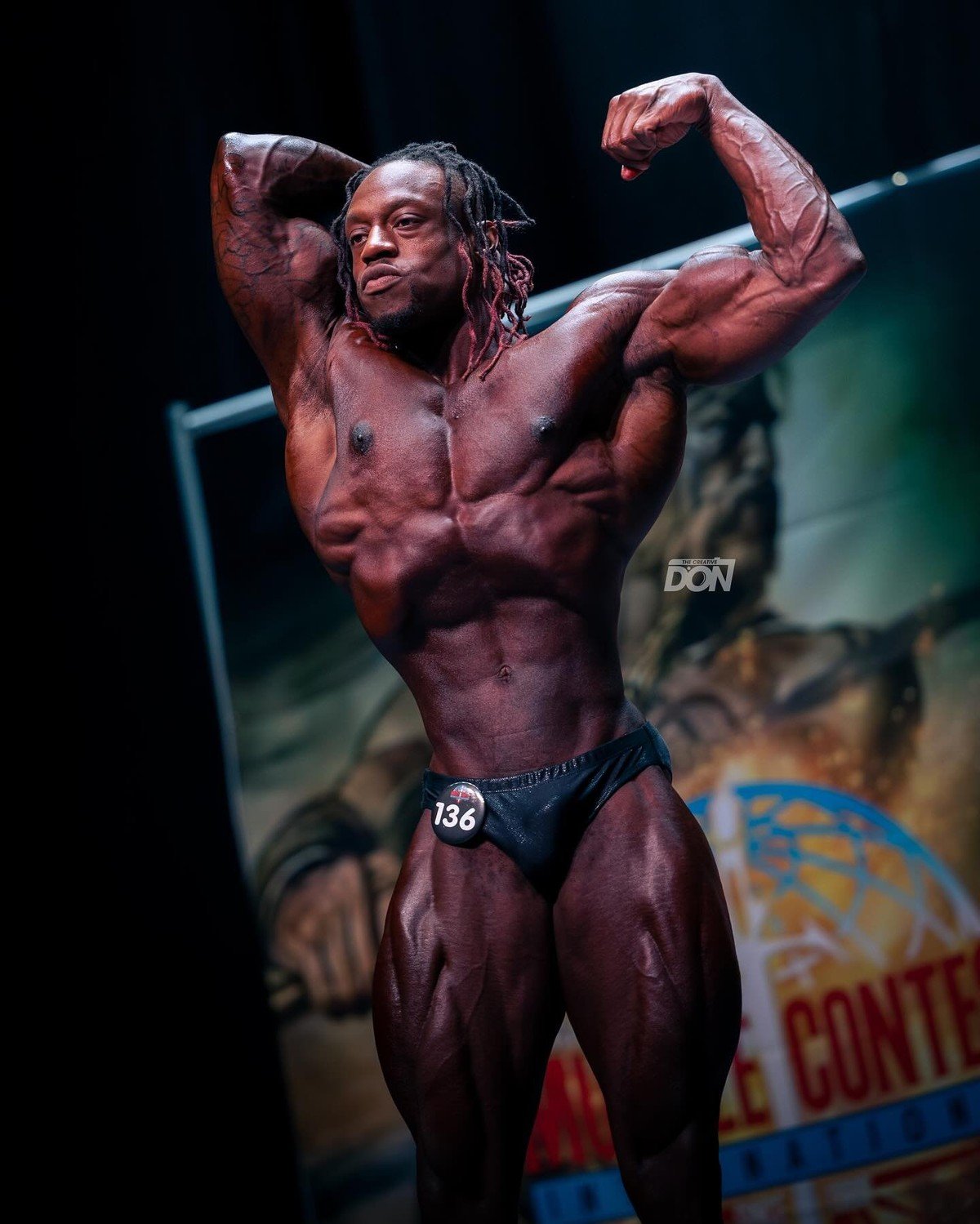 Yemi Adefioye posing on a Musclecontest stage