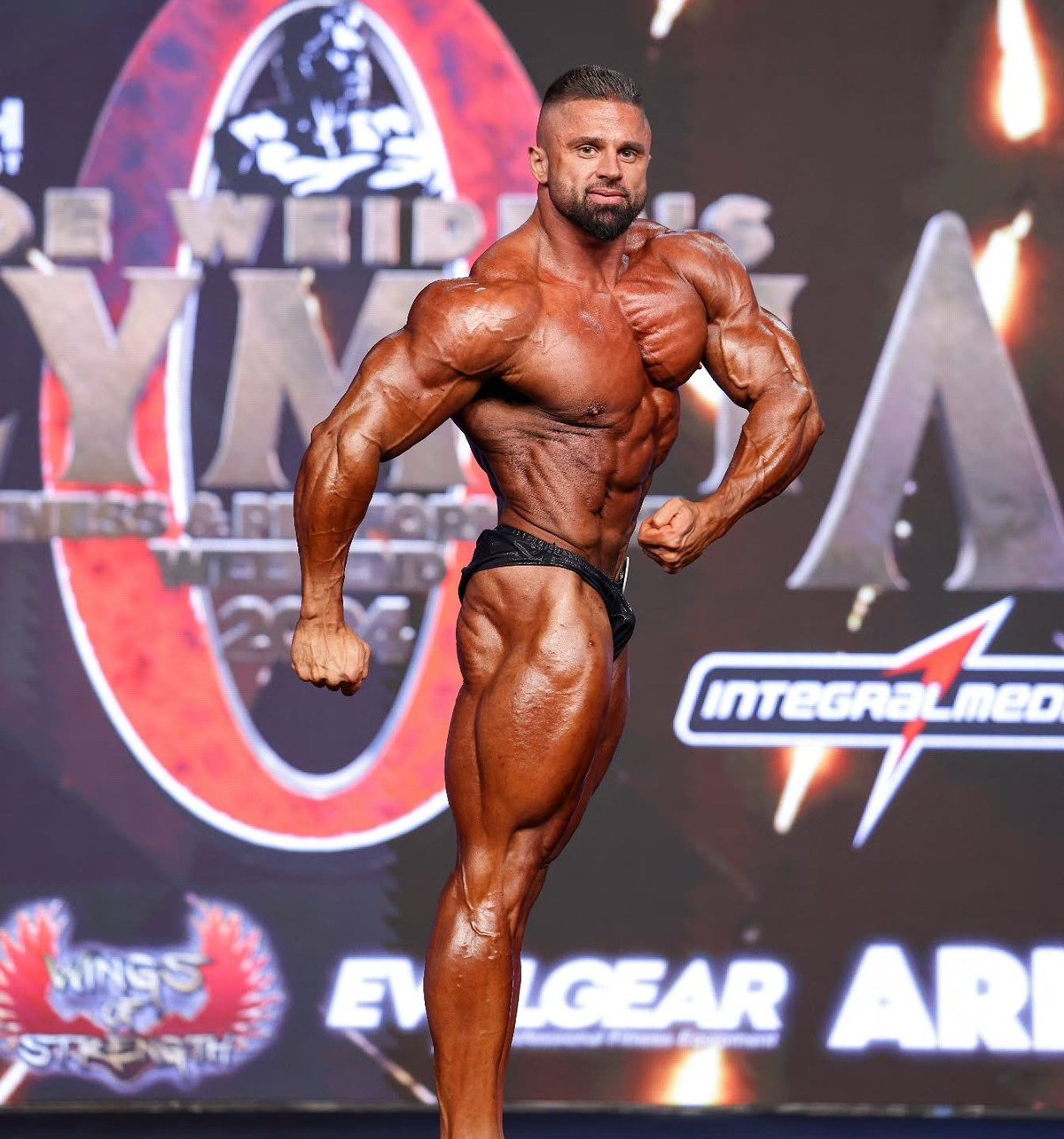 Zhivko Petkov hitting a side chest pose on the Mr. Olympia stage
