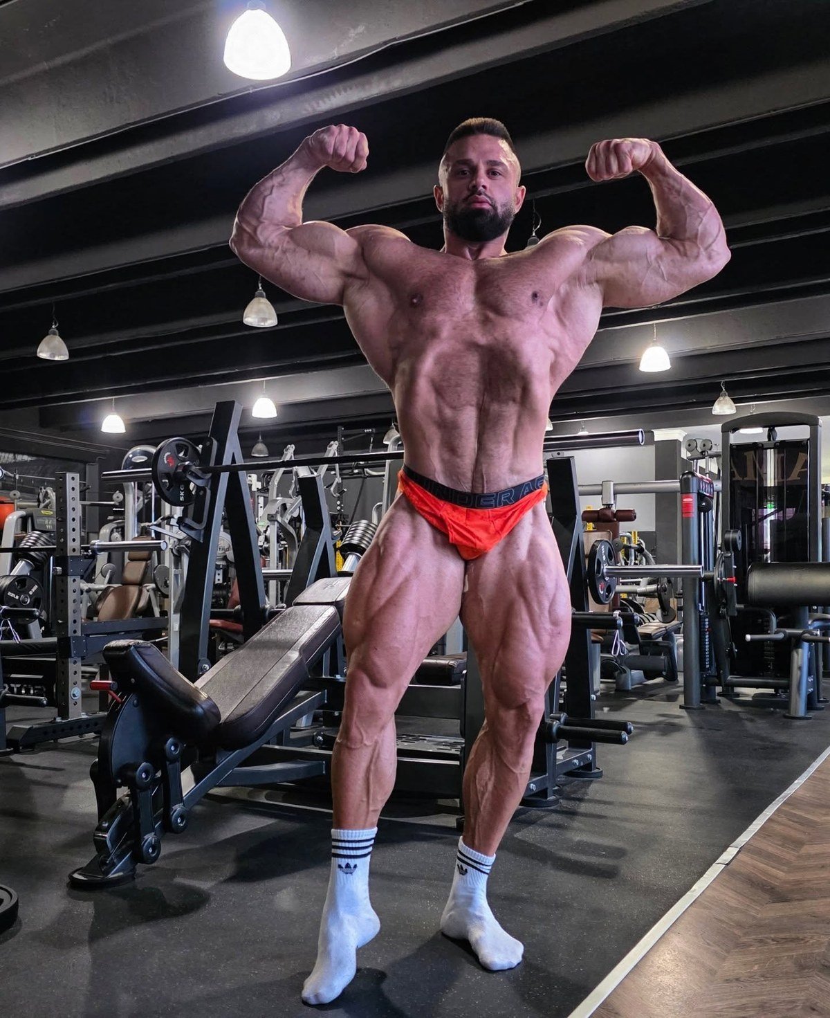 Zhivko Petkov hitting a front double biceps pose in the gym